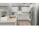 Bright kitchen showcasing stainless steel appliances, granite countertops, and access to outdoor patio at 6964 Caldera St, Las Vegas, NV 89149