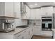 Gourmet kitchen features stainless steel appliances, granite countertops, modern backsplash, and gas cooktop at 6964 Caldera St, Las Vegas, NV 89149