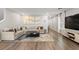 Comfortable living room featuring a large sectional sofa, area rug, and stylish entertainment center at 6964 Caldera St, Las Vegas, NV 89149