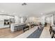 Open-concept living area with a kitchen island, stainless steel appliances, and hardwood floors at 6964 Caldera St, Las Vegas, NV 89149