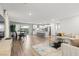 Open-concept living space featuring a kitchen, dining area, and living room with hard surface flooring at 6964 Caldera St, Las Vegas, NV 89149