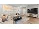 Cozy living room featuring a comfortable sectional sofa, modern decor, and a large entertainment center at 6964 Caldera St, Las Vegas, NV 89149