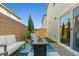 Inviting patio with a sleek fire pit, cozy seating, and sliding glass door access at 6964 Caldera St, Las Vegas, NV 89149