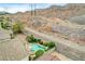 This home features a backyard oasis with a pool, spa, and mountain views in the distance at 703 Jane Eyre Pl, Henderson, NV 89002