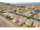 This aerial shot showcases a lovely neighborhood with well-maintained homes and desert landscaping at 703 Jane Eyre Pl, Henderson, NV 89002