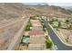 This aerial shot showcases a lovely neighborhood with well-maintained homes and desert landscaping at 703 Jane Eyre Pl, Henderson, NV 89002