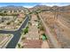 Aerial view of a desert neighborhood with mountain views and well maintained homes, including those with pools at 703 Jane Eyre Pl, Henderson, NV 89002