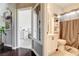 Well lit bathroom with beige walls, white vanity and shower with brown curtain at 703 Jane Eyre Pl, Henderson, NV 89002