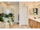 Well-lit bathroom with a tiled floor, soaking tub, separate shower, and wooden vanity at 703 Jane Eyre Pl, Henderson, NV 89002