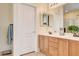 Bathroom with double sinks, wooden vanity and large mirror at 703 Jane Eyre Pl, Henderson, NV 89002