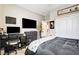 Well-organized bedroom with a desk, closet, and TV, perfect for work or relaxation at 703 Jane Eyre Pl, Henderson, NV 89002