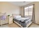 Bedroom with beige walls and gray carpet, with natural light from a window at 703 Jane Eyre Pl, Henderson, NV 89002