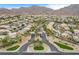 Gated community entrance with desert landscaping and palm trees against a backdrop of mountains at 703 Jane Eyre Pl, Henderson, NV 89002