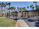 The community park boasts a pergola with picnic tables, framed by palm trees and clear skies at 703 Jane Eyre Pl, Henderson, NV 89002