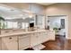 Open kitchen with white cabinetry, stainless appliances, quartz countertops, and hardwood flooring at 703 Jane Eyre Pl, Henderson, NV 89002