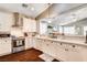Stylish kitchen featuring white cabinets, stainless steel appliances, and an open view to the living space at 703 Jane Eyre Pl, Henderson, NV 89002