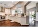 Spacious open concept kitchen features quartz countertops, stainless appliances, and dark wood floors at 703 Jane Eyre Pl, Henderson, NV 89002