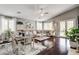 Spacious living and dining area with hardwood floors and large windows at 703 Jane Eyre Pl, Henderson, NV 89002