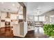 Open-concept space featuring a kitchen, dining, and living area with modern finishes and hardwood floors at 703 Jane Eyre Pl, Henderson, NV 89002