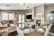 Well-lit living space with dining area, fireplace, and access to a patio at 703 Jane Eyre Pl, Henderson, NV 89002
