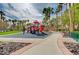 Well-maintained neighborhood playground with slides and play equipment, with palm trees and blue sky background at 703 Jane Eyre Pl, Henderson, NV 89002