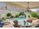 Inviting backyard featuring a pool with waterfall feature, spa, and covered patio at 703 Jane Eyre Pl, Henderson, NV 89002