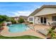 Backyard pool with attached spa and beautiful landscaping features a relaxing waterfall at 703 Jane Eyre Pl, Henderson, NV 89002