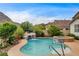 Beautiful backyard featuring a pool with a waterfall and mountains in the background at 703 Jane Eyre Pl, Henderson, NV 89002
