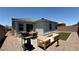 Backyard featuring patio dining, grill, artificial turf, and lounge seating at 739 Wild Highlands Ln, Henderson, NV 89015