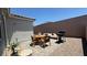Cozy backyard featuring patio dining set, grill, and comfortable lounge seating at 739 Wild Highlands Ln, Henderson, NV 89015