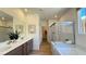 Bright bathroom with double vanity, soaking tub, and separate glass-enclosed shower at 739 Wild Highlands Ln, Henderson, NV 89015