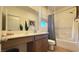 Well-lit bathroom featuring a modern vanity, mirror, and shower-tub combination at 739 Wild Highlands Ln, Henderson, NV 89015