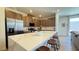 Modern kitchen featuring a large island with seating, stainless steel appliances, and quartz countertops at 739 Wild Highlands Ln, Henderson, NV 89015
