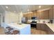 Modern kitchen featuring a large island with seating, stainless steel appliances, and ample cabinetry at 739 Wild Highlands Ln, Henderson, NV 89015