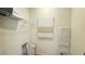 Functional laundry room with shelving, laundry basket, and space for cleaning supplies at 739 Wild Highlands Ln, Henderson, NV 89015