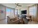 Bright living room featuring hardwood floors, large windows, and access to the outdoor patio at 739 Wild Highlands Ln, Henderson, NV 89015