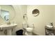 Bright powder room featuring a unique round mirror, pendant light, and a modern vanity at 739 Wild Highlands Ln, Henderson, NV 89015