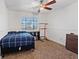 Cozy bedroom features a ceiling fan, neutral carpet, and a window with natural light at 741 Wildwood Beach Ave, Henderson, NV 89052