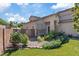 Charming front yard featuring a lush lawn, garden, and covered patio area at 741 Wildwood Beach Ave, Henderson, NV 89052