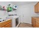 Well-lit laundry room with modern washer and dryer and a utility sink at 741 Wildwood Beach Ave, Henderson, NV 89052
