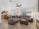Spacious living room featuring wood-look flooring, an accent fireplace, and a dining area at 741 Wildwood Beach Ave, Henderson, NV 89052