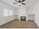 Carpeted living room with built-in fireplace and a large window at 741 Wildwood Beach Ave, Henderson, NV 89052