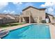 Backyard pool with surrounding patio and grassy area, perfect for outdoor relaxation and entertainment at 741 Wildwood Beach Ave, Henderson, NV 89052