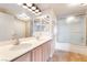 Bathroom with double sinks and shower-over-tub combination with sliding glass doors at 7450 S Eastern Ave # 1058, Las Vegas, NV 89123