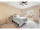 Cozy bedroom with carpet flooring, a ceiling fan and sliding door access to a patio at 7450 S Eastern Ave # 1058, Las Vegas, NV 89123