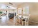 Cozy dining area off living room features modern table, tile floors, and plantation shutters at 7450 S Eastern Ave # 1058, Las Vegas, NV 89123