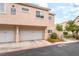 Condo building with two-car garages and well-manicured landscaping at 7450 S Eastern Ave # 1058, Las Vegas, NV 89123
