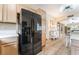 Kitchen featuring black refrigerator, light wood cabinets, and tile floors at 7450 S Eastern Ave # 1058, Las Vegas, NV 89123