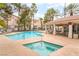 Inviting community pool area with a hot tub, seating, and lush landscaping at 7450 S Eastern Ave # 1058, Las Vegas, NV 89123