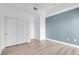 Bright bedroom features neutral tones, wood-look floors, and ample closet space at 75 E Agate Ave # 206, Las Vegas, NV 89123